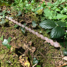 Load image into Gallery viewer, A stunning handcrafted unicorn magic wand made with shimmering rose quartz chips, showcasing a blend of pink hues. The wand has a gracefully tapered shaft that sparkles in light, showcasing its intricate craftsmanship. Perfect for fantasy collectors, this wand embodies elegance and enchantment, making it a prized addition to any magical assortment.