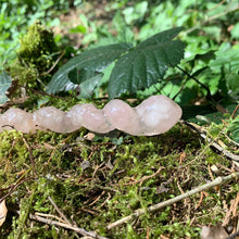 Load image into Gallery viewer, A stunning handcrafted unicorn magic wand made with shimmering rose quartz chips, showcasing a blend of pink hues. The wand has a gracefully tapered shaft that sparkles in light, showcasing its intricate craftsmanship. Perfect for fantasy collectors, this wand embodies elegance and enchantment, making it a prized addition to any magical assortment.