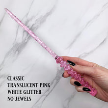 Lade das Bild in den Galerie-Viewer, A stunning pink celestial-inspired Orbit design magic wand featuring a delicate, translucent design with iridescent shimmering accents. The wand has a beautiful handle with alternating hoops with a narrow shaft that sparkles in light, showcasing its intricate craftsmanship. Perfect for fantasy collectors, this wand embodies elegance and enchantment, making it a prized addition to any magical assortment.