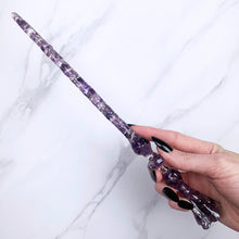 Load image into Gallery viewer, A stunning handcrafted Flora magic wand made with shimmering amethyst chips, showcasing a blend of purple hues. The wand has a gracefully tapered shaft that sparkles in light, showcasing its intricate craftsmanship. Perfect for fantasy collectors, this wand embodies elegance and enchantment, making it a prized addition to any magical assortment.