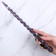 Load image into Gallery viewer, A stunning handcrafted unicorn magic wand made with shimmering amethyst chips, showcasing a blend of purple hues. The wand has a gracefully tapered shaft that sparkles in light, showcasing its intricate craftsmanship. Perfect for fantasy collectors, this wand embodies elegance and enchantment, making it a prized addition to any magical assortment.