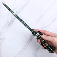 Load image into Gallery viewer, A stunning handcrafted Flora magic wand made with shimmering aventurine chips, showcasing a blend of green hues. The wand has a gracefully tapered shaft that sparkles in light, showcasing its intricate craftsmanship. Perfect for fantasy collectors, this wand embodies elegance and enchantment, making it a prized addition to any magical assortment.