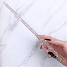 Load image into Gallery viewer, A stunning handcrafted Flora magic wand made with shimmering rose quartz chips, showcasing a blend of pink hues. The wand has a gracefully tapered shaft that sparkles in light, showcasing its intricate craftsmanship. Perfect for fantasy collectors, this wand embodies elegance and enchantment, making it a prized addition to any magical assortment.