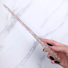 Lade das Bild in den Galerie-Viewer, A stunning handcrafted Twist magic wand made with shimmering rose quartz chips, showcasing a blend of pink hues. The wand has a gracefully tapered shaft that sparkles in light, showcasing its intricate craftsmanship. Perfect for fantasy collectors, this wand embodies elegance and enchantment, making it a prized addition to any magical assortment.