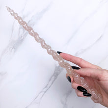Load image into Gallery viewer, A stunning handcrafted unicorn magic wand made with shimmering rose quartz chips, showcasing a blend of pink hues. The wand has a gracefully tapered shaft that sparkles in light, showcasing its intricate craftsmanship. Perfect for fantasy collectors, this wand embodies elegance and enchantment, making it a prized addition to any magical assortment.