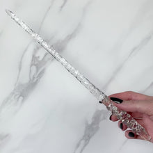 Load and play video in Gallery viewer, A stunning clear Twist design magic wand featuring a delicate, translucent design with iridescent shimmering accents. The wand has a beautiful twisted handle with with a narrow shaft that sparkles in light, showcasing its intricate craftsmanship. Perfect for fantasy collectors, this wand embodies elegance and enchantment, making it a prized addition to any magical assortment.