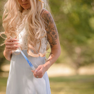 fairy with tattoo holding blue and white wand with white opal crystals