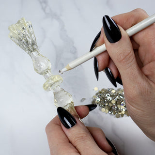 Handmade magic wand being embellished with crystals