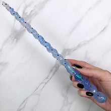 Charger l&#39;image dans la galerie, A stunning blue and white unicorn magic wand featuring a delicate, translucent design with iridescent shimmering accents. The wand has a gracefully tapered shaft that sparkles in light, showcasing its intricate craftsmanship. Perfect for fantasy collectors, this wand embodies elegance and enchantment, making it a prized addition to any magical assortment.
