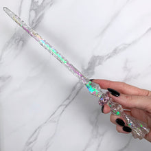 Lade das Bild in den Galerie-Viewer, A stunning clear Flora magic wand featuring a delicate, translucent design with iridescent shimmering accents. The wand has a beautiful flower shaped base with a narrow shaft that sparkles in light, showcasing its intricate craftsmanship. Perfect for fantasy collectors, this wand embodies elegance and enchantment, making it a prized addition to any magical assortment.

