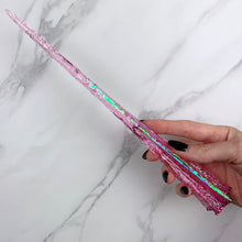 Lade das Bild in den Galerie-Viewer, A stunning pink Star design magic wand featuring a delicate, translucent design with iridescent shimmering accents. The wand has a beautiful star shaped base that gracefully tapers to a point that sparkles in light, showcasing its intricate craftsmanship. Perfect for fantasy collectors, this wand embodies elegance and enchantment, making it a prized addition to any magical assortment.
