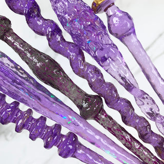 Close up of mystery wands in various shades of purple.