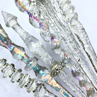 Close of of magic wands in various clear  translucent options on a white background.