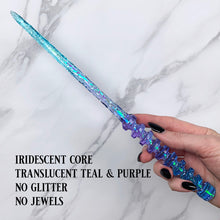 Charger l&#39;image dans la galerie, A stunning teal and purple celestial-inspired Orbit design magic wand featuring a delicate, translucent design with iridescent shimmering accents. The wand has a beautiful handle with alternating hoops with a narrow shaft that sparkles in light, showcasing its intricate craftsmanship. Perfect for fantasy collectors, this wand embodies elegance and enchantment, making it a prized addition to any magical assortment.
