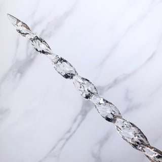 A unique handmade magic wand made with real purple amethyst crystal chips, in the Mertail  Design. 

A detailed  spiral of the shaft of the wand is on a white marbled background. 