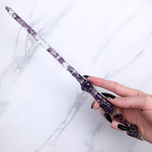 Charger l&#39;image dans la galerie, A stunning handcrafted Stiletto magic wand made with shimmering amethyst chips, showcasing a blend of purple hues. The wand has a gracefully tapered shaft that sparkles in light, showcasing its intricate craftsmanship. Perfect for fantasy collectors, this wand embodies elegance and enchantment, making it a prized addition to any magical assortment.
