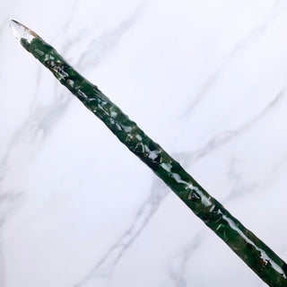 A unique handmade magic wand made with real green aventurine crystal chips, in the Twist Design. 

On a white marbled background.