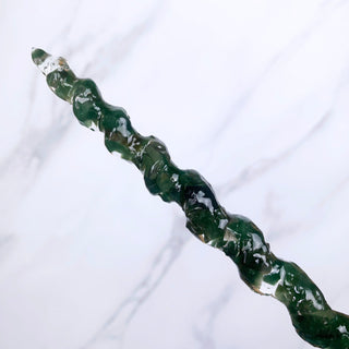 A unique handmade magic wand made with real green aventurine crystal chips, in the Unicorn Design. 

On a white marbled background.