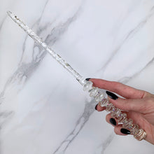 Charger l&#39;image dans la galerie, A stunning clear celestial-inspired Orbit design magic wand featuring a delicate, translucent design with iridescent shimmering accents. The wand has a beautiful handle with alternating hoops with a narrow shaft that sparkles in light, showcasing its intricate craftsmanship. Perfect for fantasy collectors, this wand embodies elegance and enchantment, making it a prized addition to any magical assortment.
