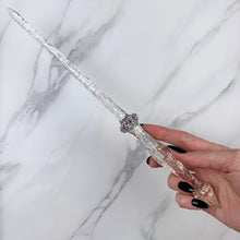 Load image into Gallery viewer, A stunning clear Stiletto design magic wand featuring a delicate, translucent design with iridescent shimmering accents. The wand has a beautiful smooth handle that tapers to a point with a narrow shaft that sparkles in light, showcasing its intricate craftsmanship. Perfect for fantasy collectors, this wand embodies elegance and enchantment, making it a prized addition to any magical assortment.
